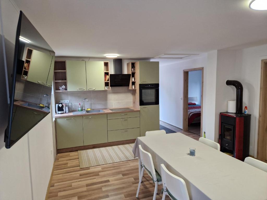 a kitchen and dining room with a table and chairs at Apartma Tija in Tolmin