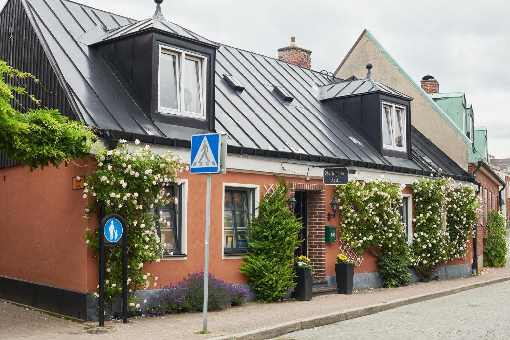 a house with a blue sign in front of it at Hotell Bäckagården in Ystad