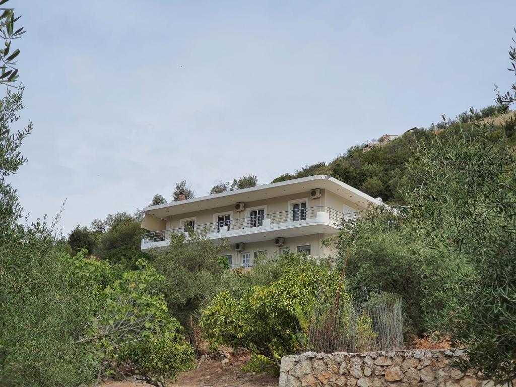 a house on the side of a hill at Bodini's Rooms in Himare