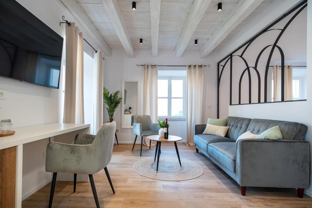 a living room with a couch and a table at Shee-Lu Suites in Dubrovnik