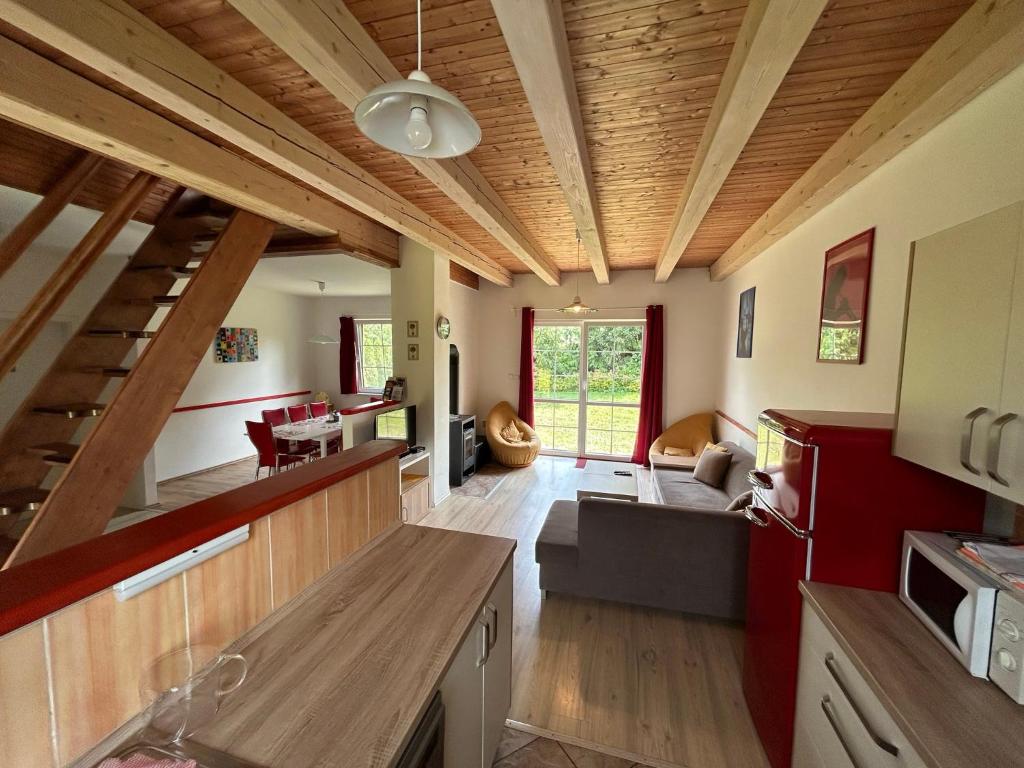 a kitchen and living room with wooden ceilings at Chalupa Měňany - Karlštejn in Beroun