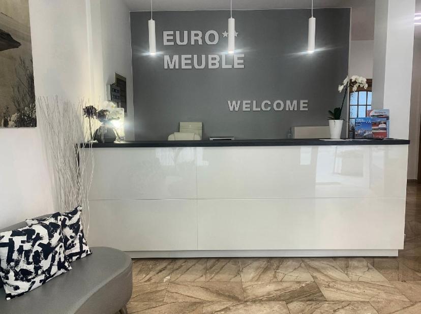 a store with a counter with a welcome sign at Euro Meublé in Grado