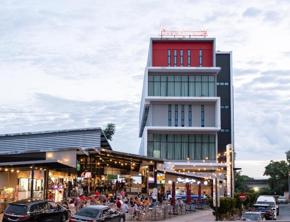 a building with cars parked in front of it at Beverly Hotel in Taiping