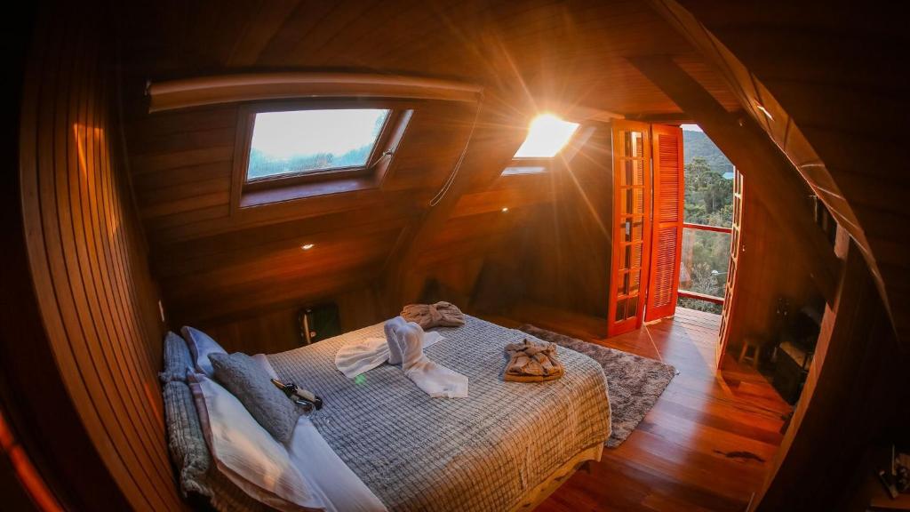 ein Schlafzimmer mit einem Bett in einem Baumhaus in der Unterkunft Mansão Austríaca Guesthouse in Campos do Jordão