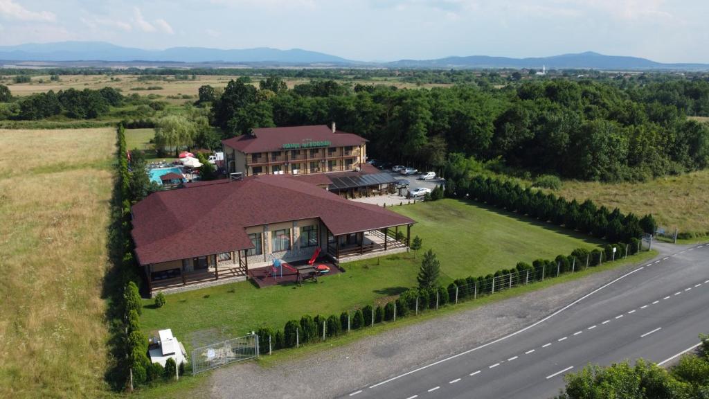 an aerial view of a house on a field with a road at Hanul Lui Bogdan Economy INN in Făget