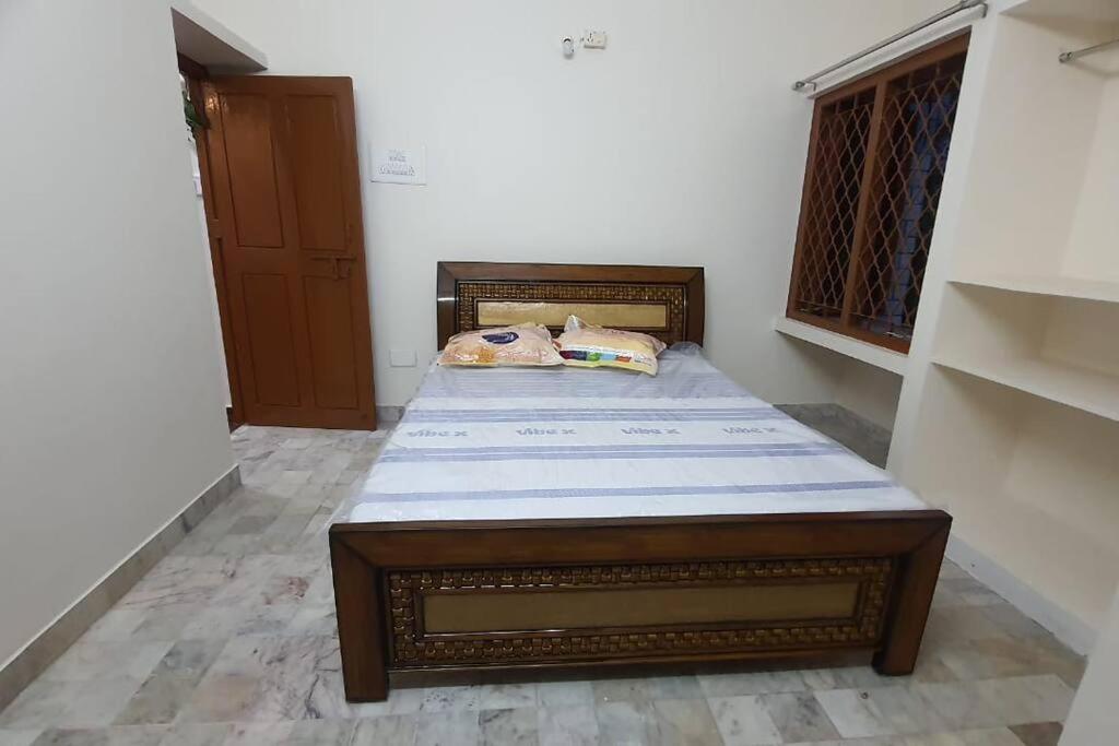 a bedroom with a bed in a room at Newly renovated & furnished 2-Bedroom MVP colony in Visakhapatnam