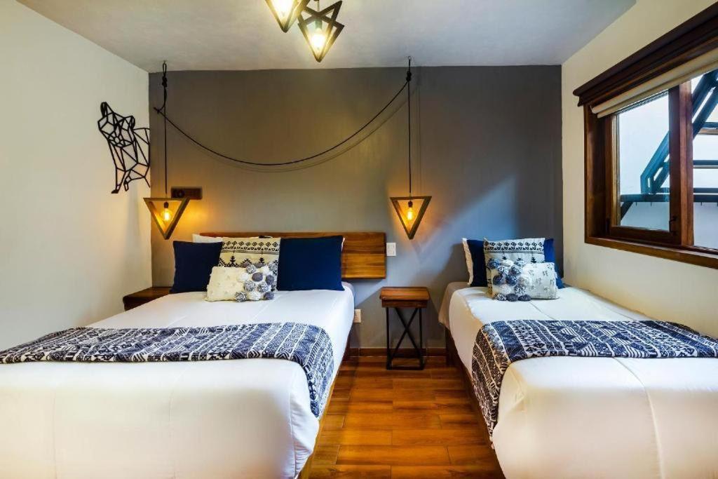Postel nebo postele na pokoji v ubytování Hotel Kali
