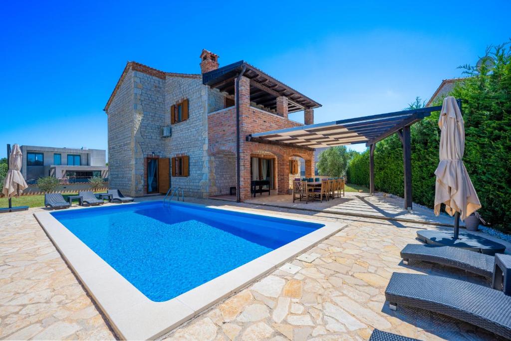 an external view of a villa with a swimming pool at Villa 9 MANI in Butkovići