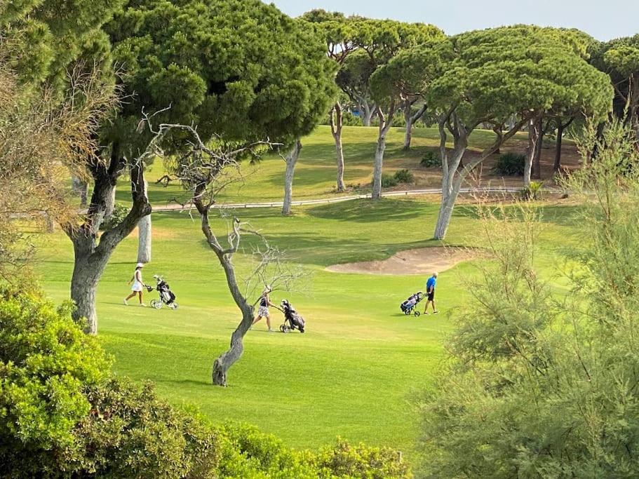 a group of people playing golf in a park at Sunny Villa with golf front view in Vilamoura