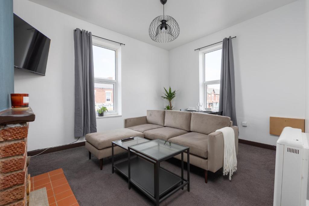 a living room with a couch and a table at Prism Everyday - One Bed Apartment in Blackpool