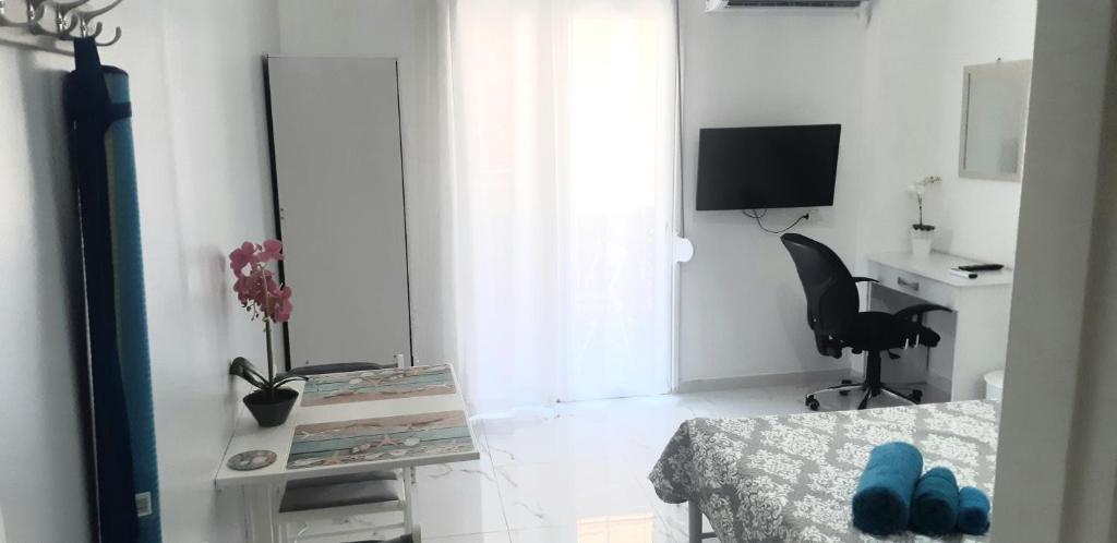 a white room with a table and a chair and a desk at Luxury apartment 3 rooms near metro in Athens