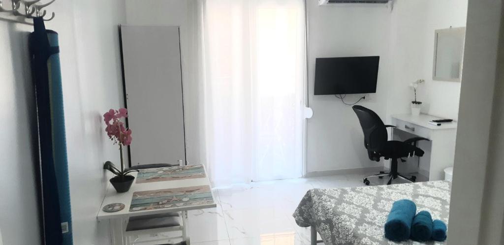 a white room with a table and a chair and a desk at Luxury apartment near metro by hospitality gr in Athens
