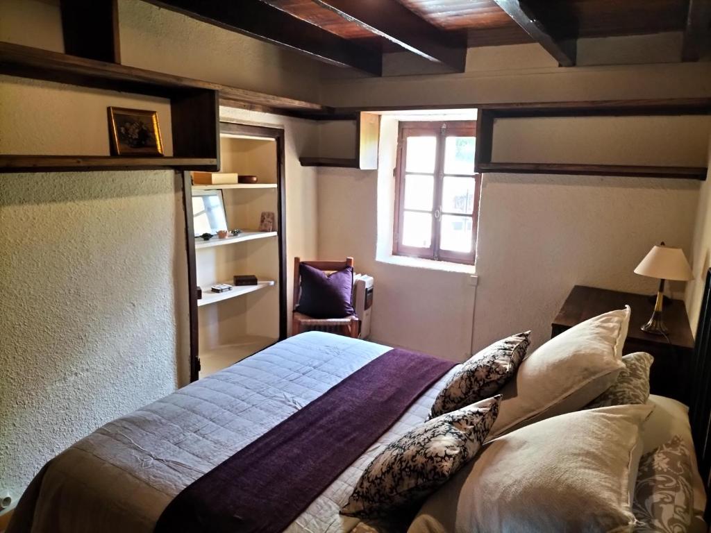 a bedroom with a large bed with a window at Maison en Cerdagne avec belle vue in Enveitg