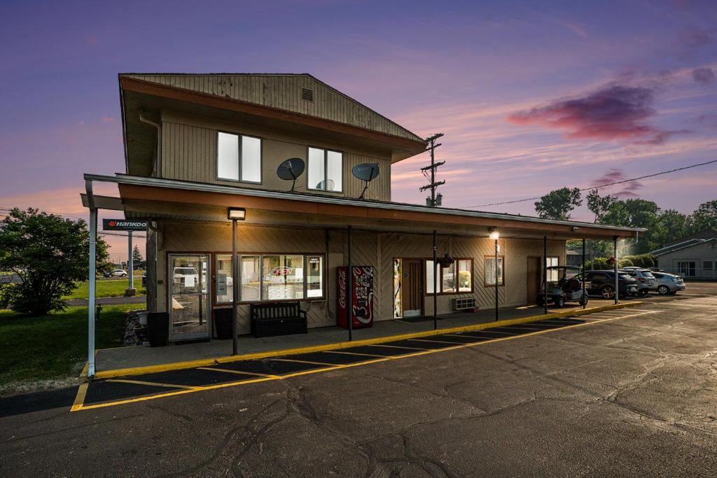 un bâtiment dans un parking avec station-service dans l'établissement Great Lakes Inn & Suites, à South Haven