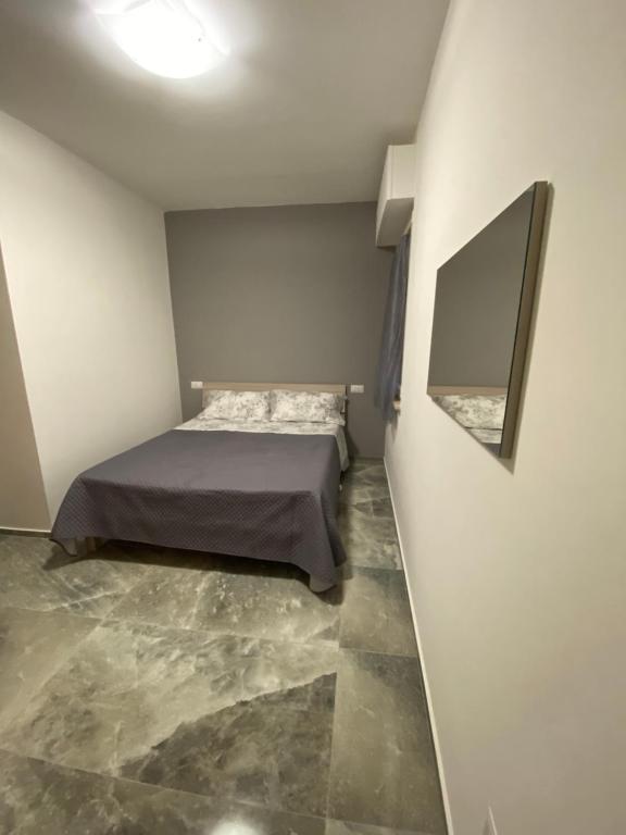 a bedroom with a bed and a flat screen tv at Appartamento per vacanze in Porto SantʼElpidio