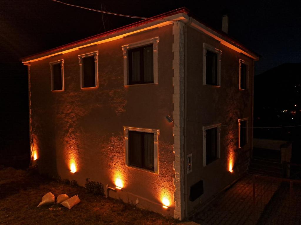 a building with lights on the side of it at night at Yılmaz Villa in Macka