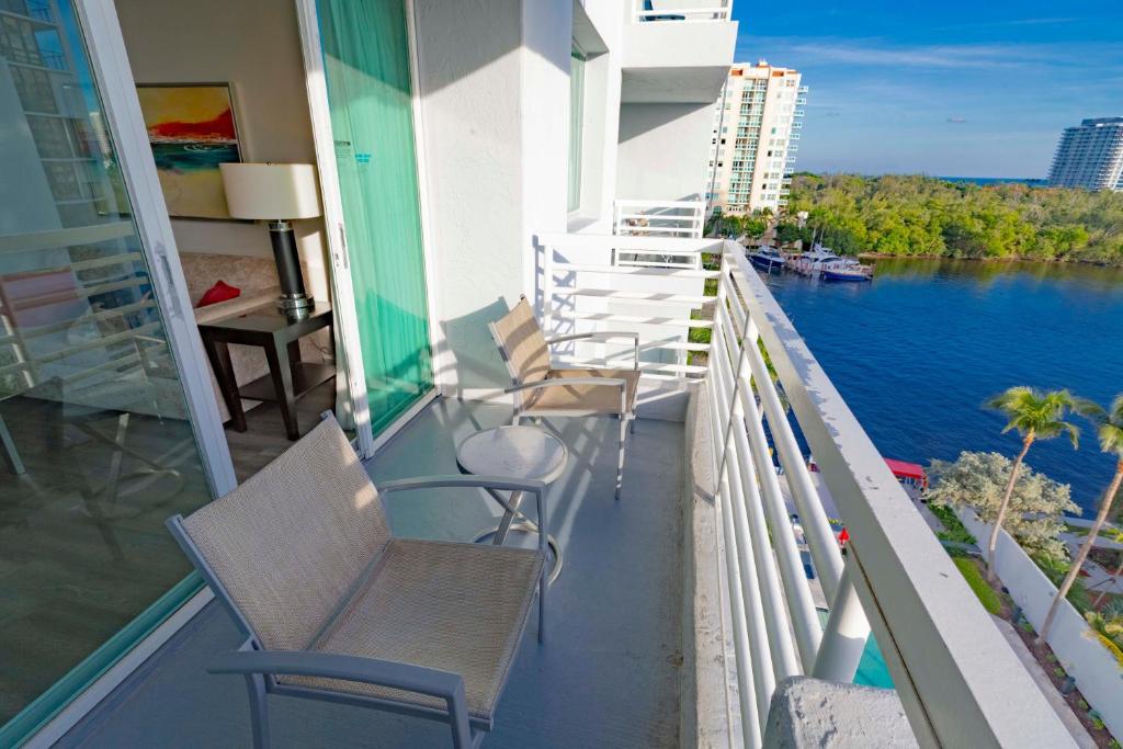 a balcony with chairs and a view of the water at Intracoastal Waterview - Central- Fort Lauderdale - Steps to Beach in Fort Lauderdale