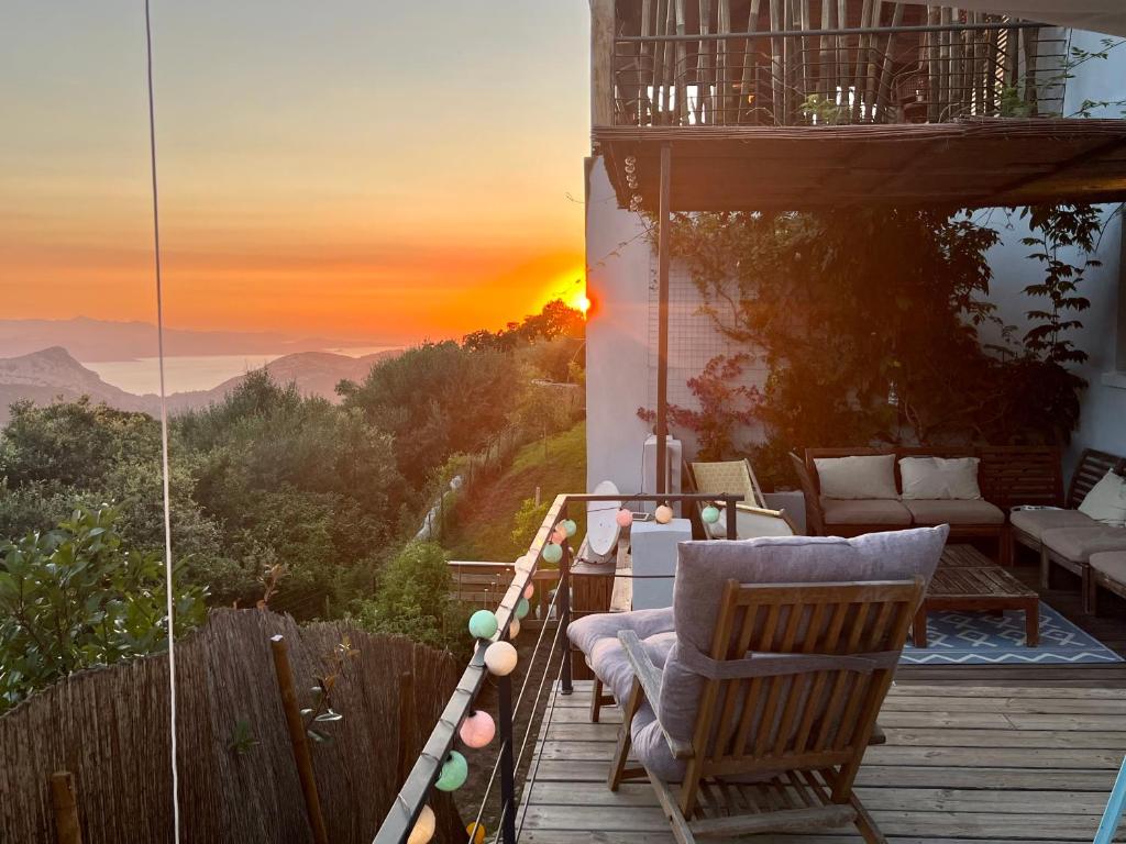 a balcony with a view of the mountains at sunset at Casa Costa in Barbaggio