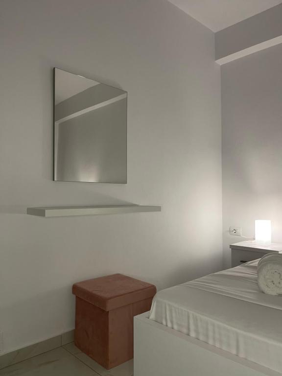 a white room with a bed and a mirror at Villa Angelina Ksamil in Ksamil