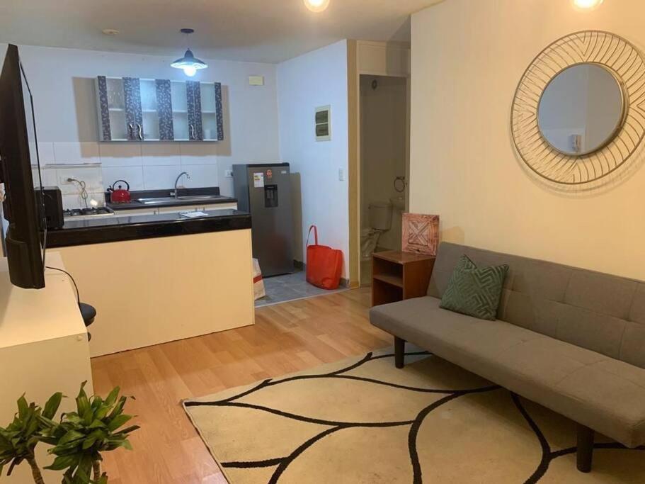 a living room with a couch and a kitchen at 807. Departamento entero en Chorrillos in Lima