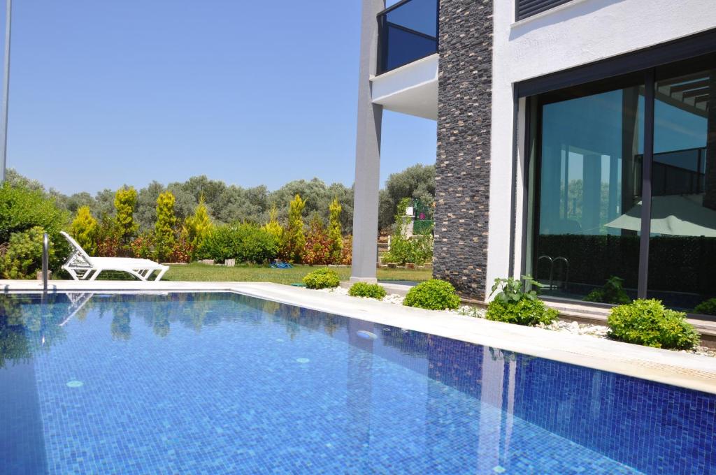 a swimming pool in front of a building at Villa Elite in Kusadası