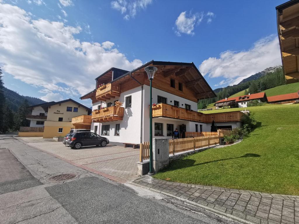 a building with a car parked in front of it at Appartement Lackner in Filzmoos