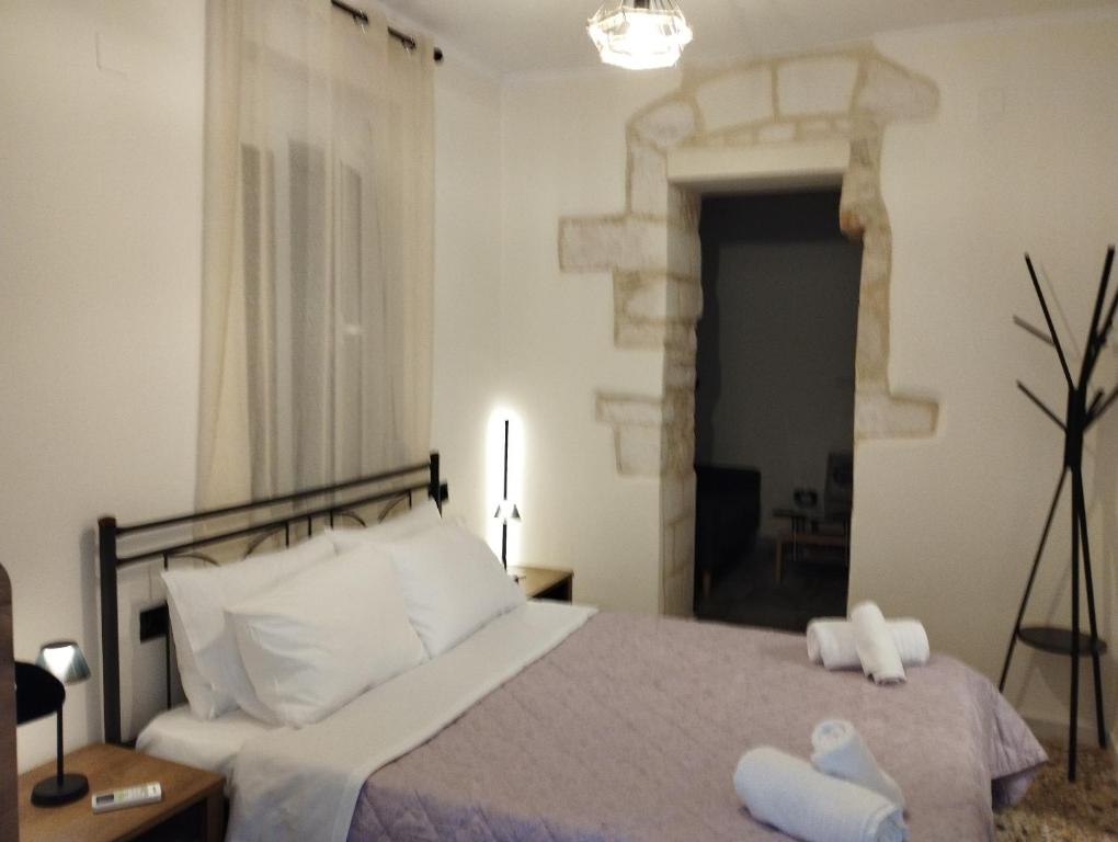 a bedroom with a bed with two towels on it at Arcade City Apartment in Rethymno