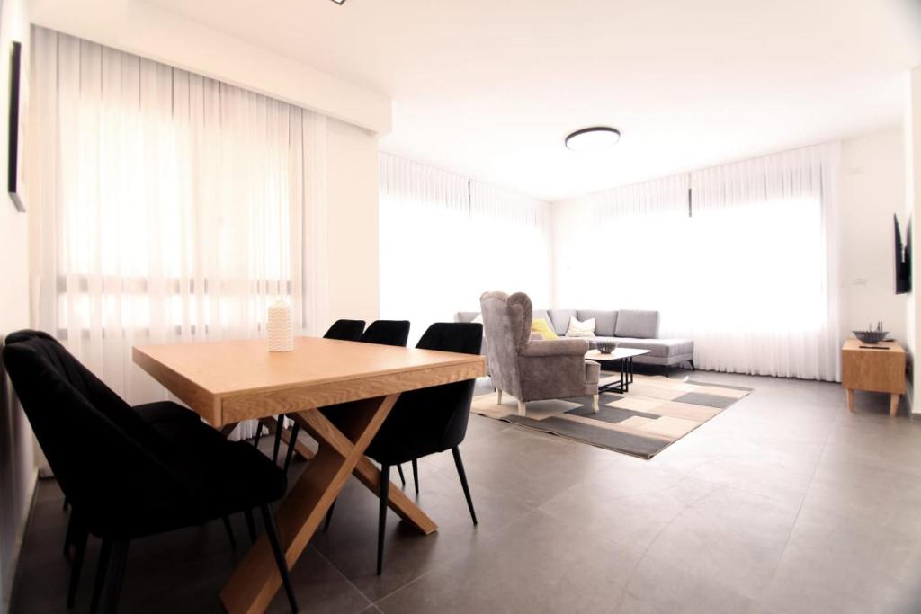 a dining room with a table and chairs at Sea view luxury Apartment in H̱adera