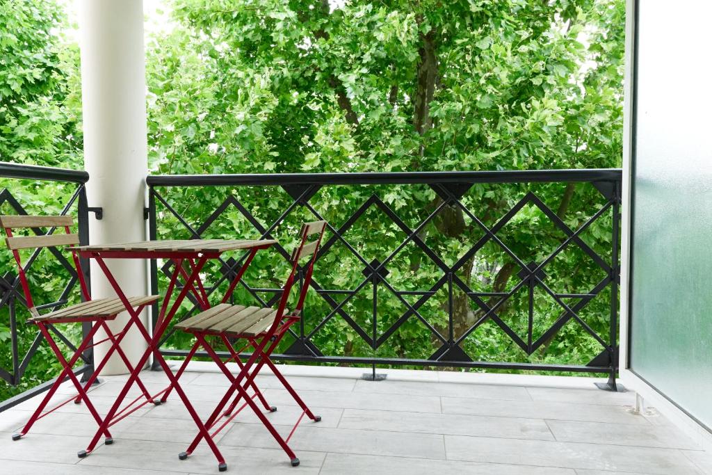 a pair of chairs and a table on a balcony at Appartement located at 15 mn from Paris & Orly in Choisy-le-Roi