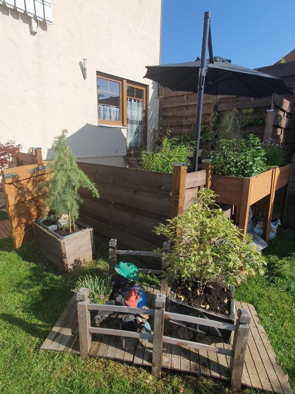 a doll sitting in a garden with potted plants at FeWo Weismark in Trier