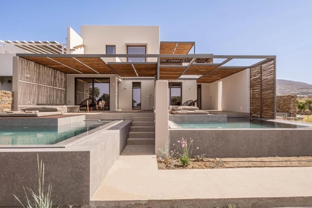 a modern house with a swimming pool at Yenesis Seaside Retreat - Adults only in Tinos Town