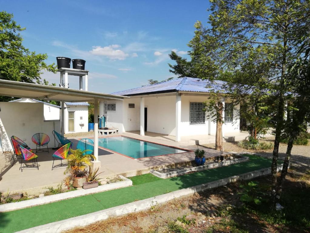 uma casa com uma piscina e um quintal em Casa Campestre con Piscina Jacuzzi y Golfito em Villavicencio