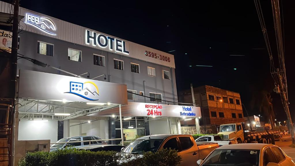 a hotel with cars parked in front of it at Sobradinho Hotel in Sobradinho