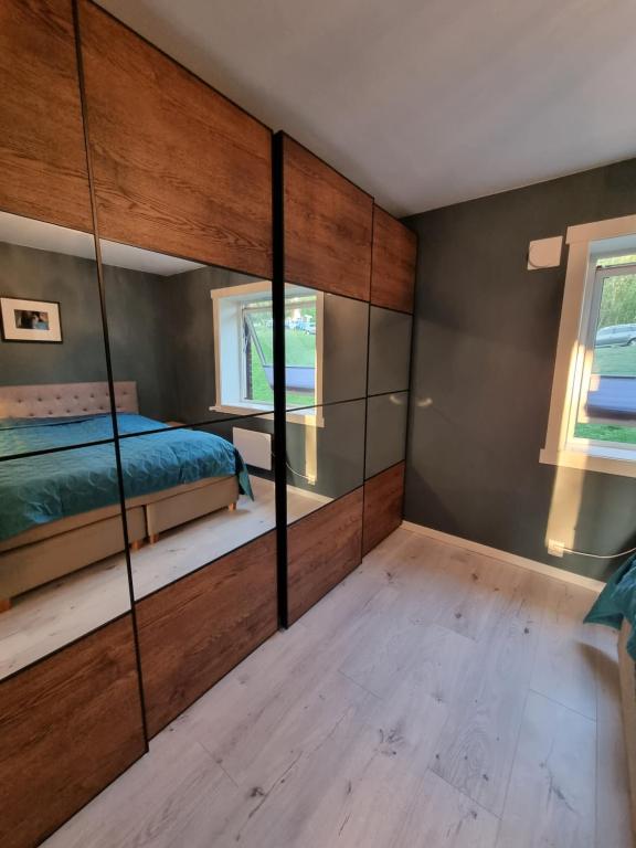 a bedroom with a bed and a mirror wall at Private room in Oslo in Oslo