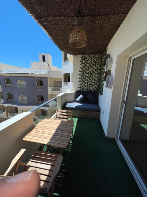 a balcony with benches and a couch on a building at Binishty hurghada apartment in Hurghada