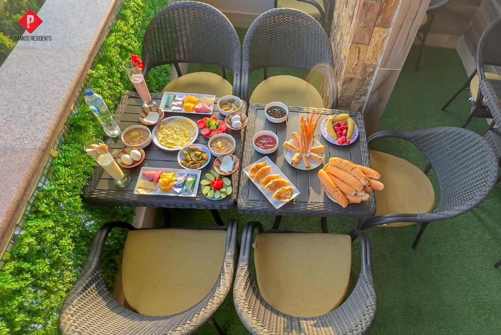 a table with food on it on a patio at Pyramids Residence view inn in Cairo