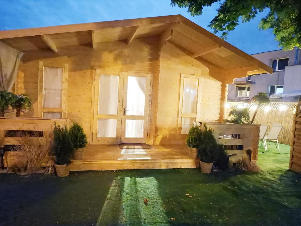 a small wooden house with a large door at Dreamholia in Jastarnia