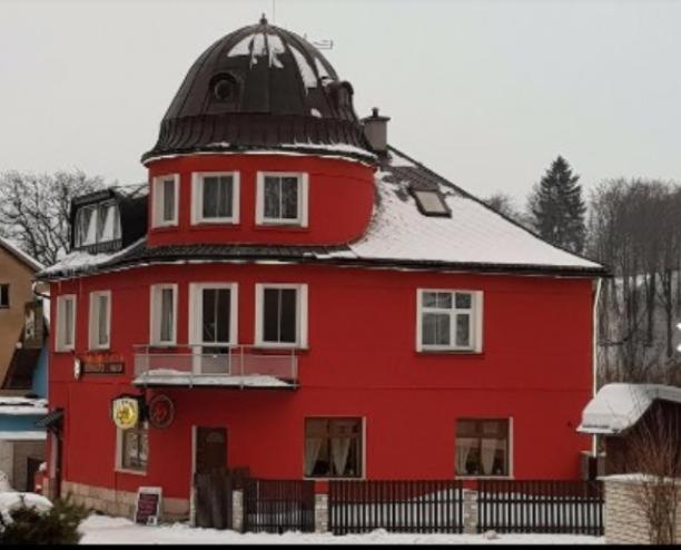 a red building with a dome on top of it at Penzion u Jakuba in Svoboda nad Úpou