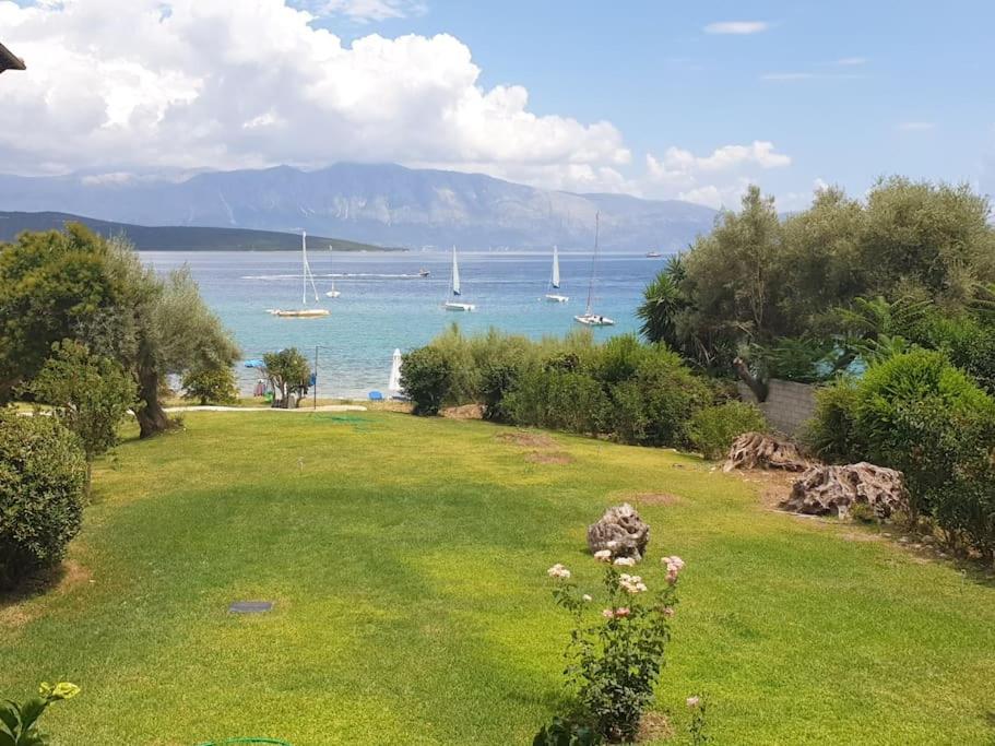 a yard with a view of the water and boats at By the sea in Nikiana