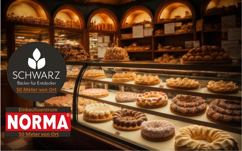 a display case in a bakery with different types of donuts at 3Room-Central-Modern near MTU- The Zeppelin by Lakescape FeWos in Friedrichshafen