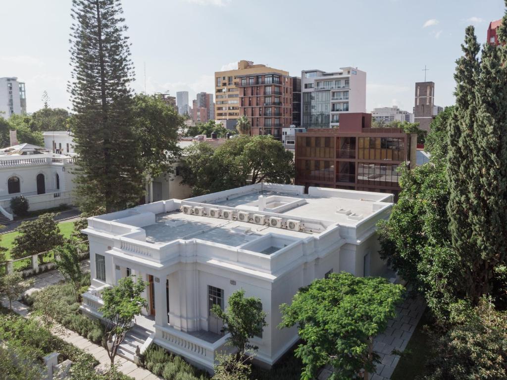 an aerial view of a white building in a city at Casa Bosque Eduviges in Guadalajara