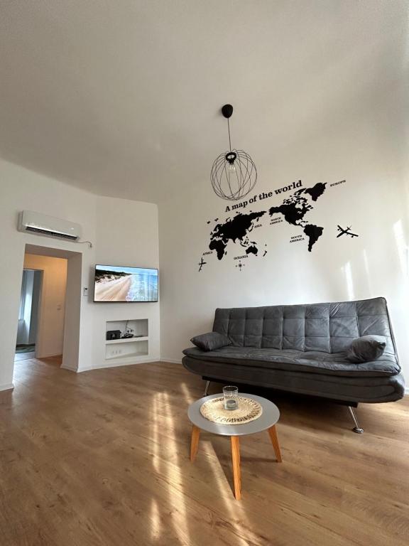 un soggiorno con divano e una mappa del mondo sul muro di Nina & Lola a Fiume (Rijeka)