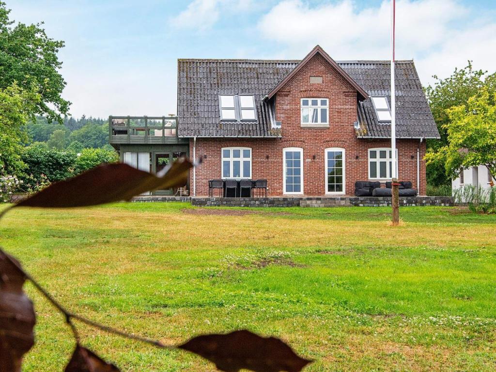 a large brick house with a grass yard at Holiday home Bjert XXII in Binderup Strand