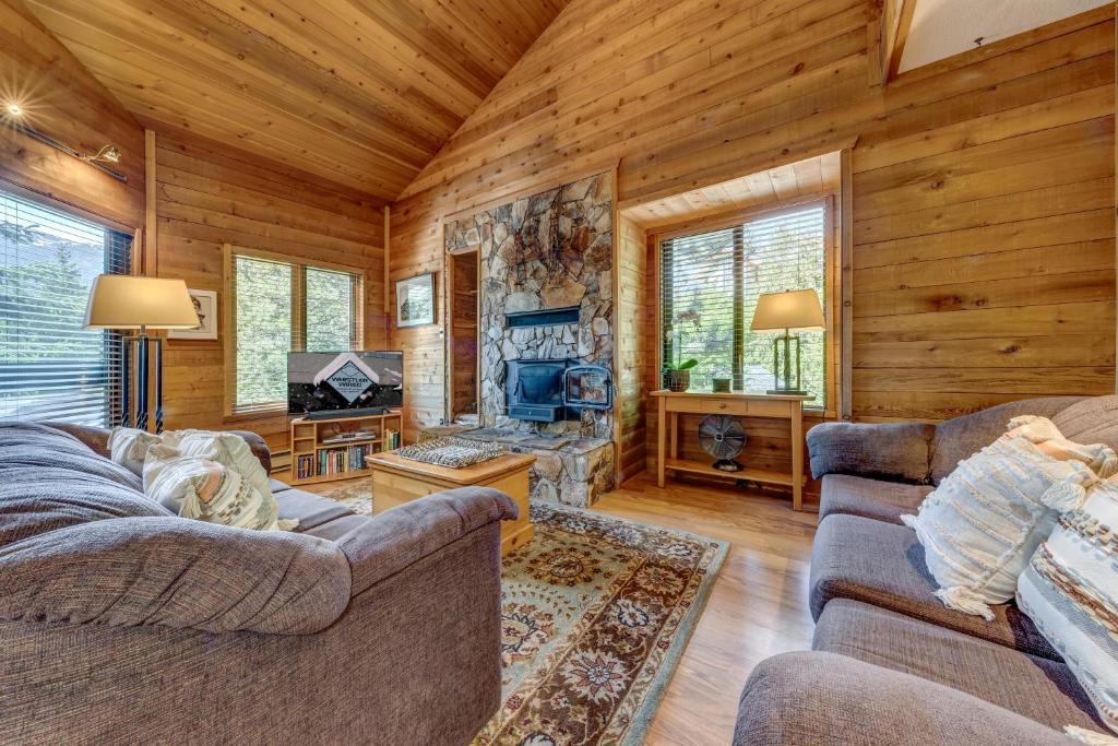 a living room with two couches and a television in a cabin at Telemark 8 in Whistler