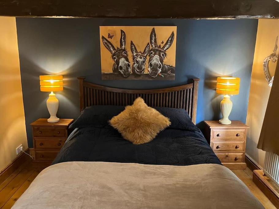 a bedroom with a bed with two night stands and two lamps at The Annexe in Winterbourne