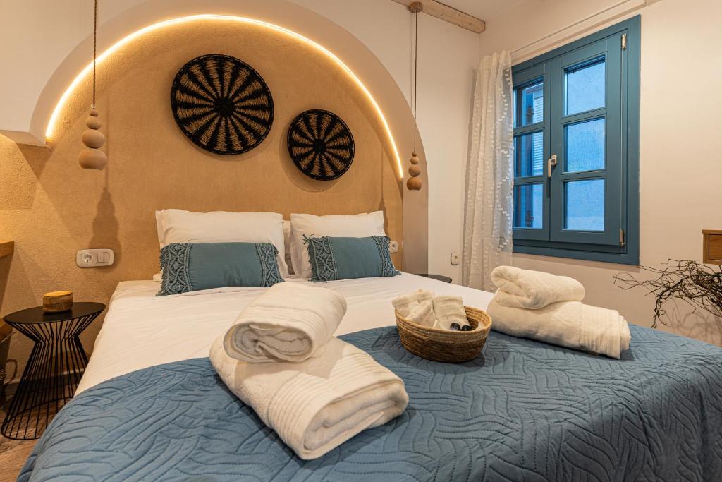 a bedroom with a large bed with towels on it at Mosaic Luxury Home in Rhodes Town
