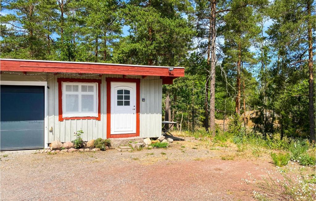 a small house with a red and white at Amazing Apartment In Figeholm With Wifi in Figeholm