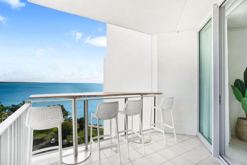 a balcony with chairs and a view of the ocean at Ocean Views at Mantra Trilogy in Cairns