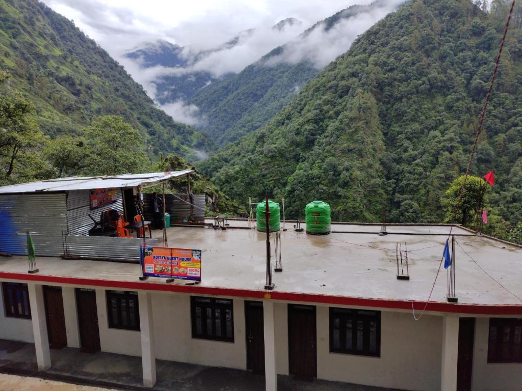 a building with a view of a mountain at Aditya guest House and restaurant in Trijugi Nārāyan
