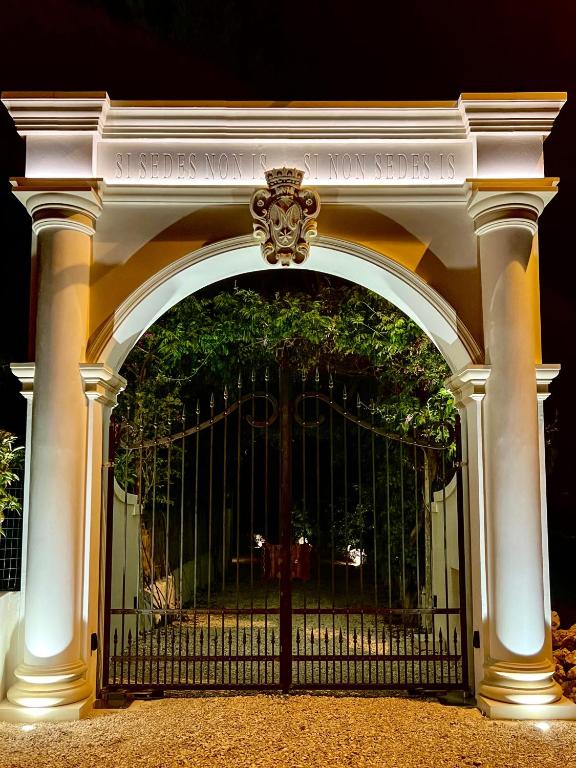 an archway with a gate with a tree behind it at Masseria Principe di Puglia in San Vito dei Normanni